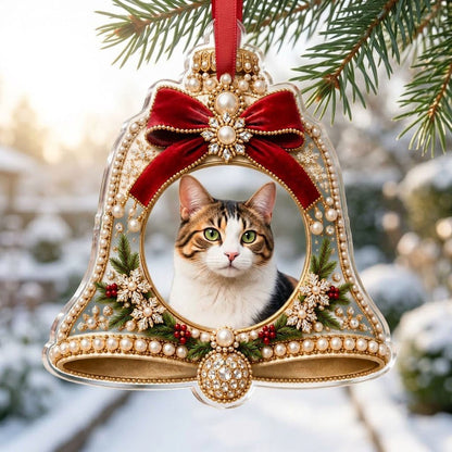 Bell-shaped acrylic ornament with red velvet bow, pearl and gold accents, and a central circular photo frame.