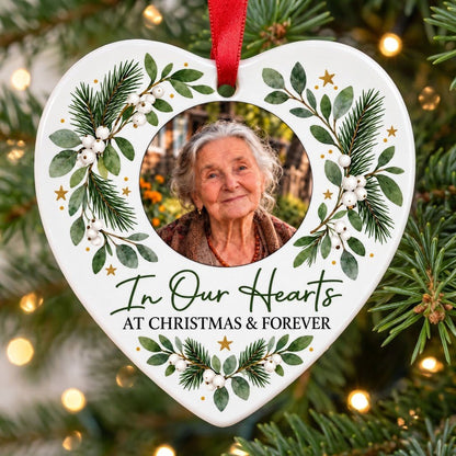 Heart ceramic ornament with In Our Hearts and AT CHRISTMAS & FOREVER around a circular photo frame with green foliage.