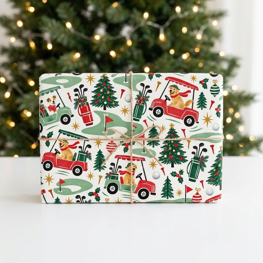 Cream wrapping paper with golden retrievers driving red and green golf carts among Christmas trees and golf icons.