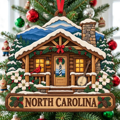 Log cabin ornament with NORTH CAROLINA banner, red cardinal, banjo, dogwood flowers, pine trees, and blue mountains.