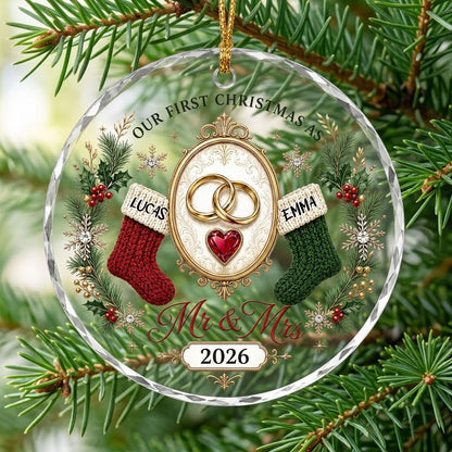 Round glass ornament with gold rings, red heart gem, red and green stockings, pine branches and Mr & Mrs text.