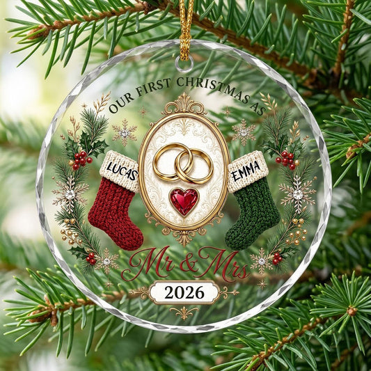 Round glass ornament with gold rings, red heart gem, red and green stockings, pine branches and Mr & Mrs text.