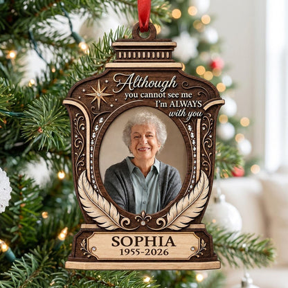 Lantern-shaped memorial wood ornament with oval photo, two feathers, starburst, fleur-de-lis and scrollwork accents.