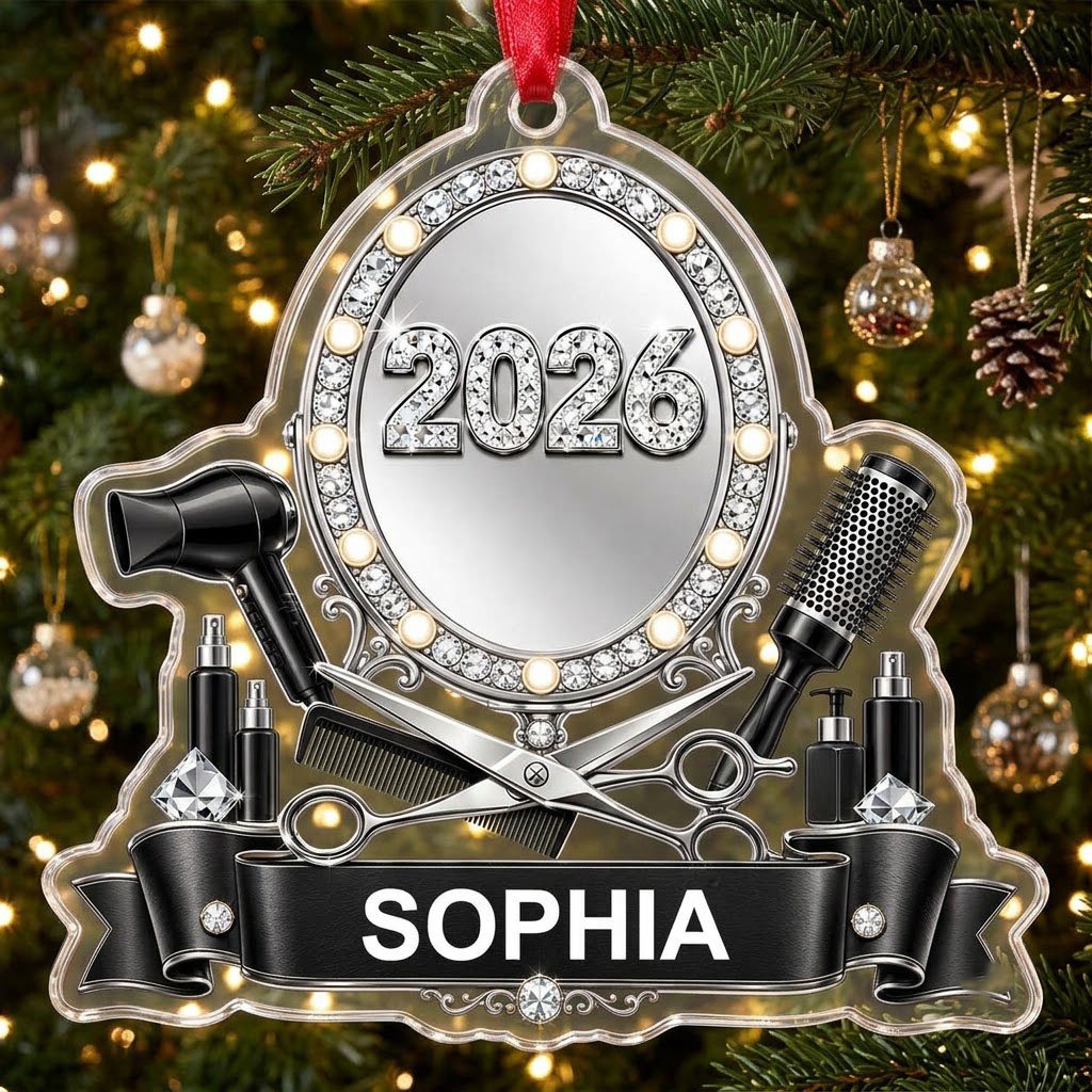 Clear acrylic ornament with a lit vanity mirror and salon tools, featuring SOPHIA and 2026 on a black banner.