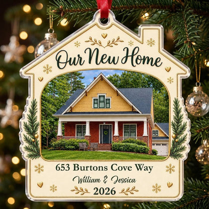 House-shaped acrylic ornament with “Our New Home”, a house photo frame, pine boughs, gold hearts and snowflakes.