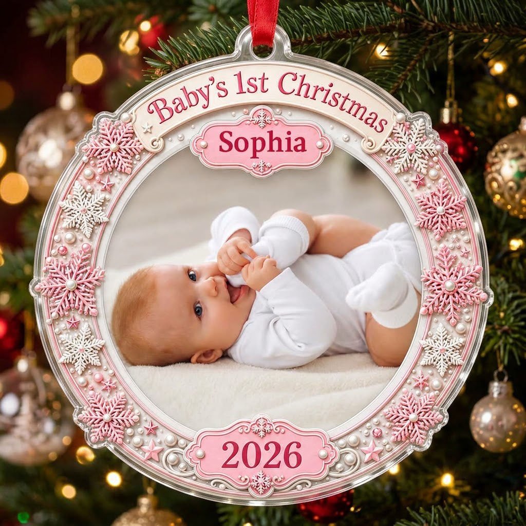 Round acrylic ornament with pink and white snowflakes framing a baby photo and the words Baby's 1st Christmas.