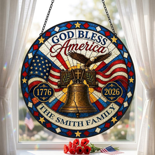 Round stained-glass style suncatcher with Liberty Bell, eagle, flags, 'GOD BLESS America' 1776–2026 and a family name