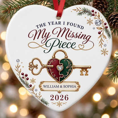 Heart ceramic ornament with a gold key through a burgundy and green heart lock, pine sprigs, berries, and gold snowflake
