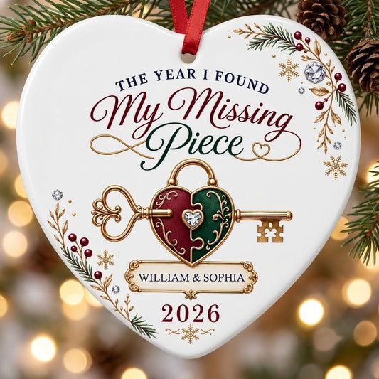 Heart ceramic ornament with a gold key through a burgundy and green heart lock, pine sprigs, berries, and gold snowflake