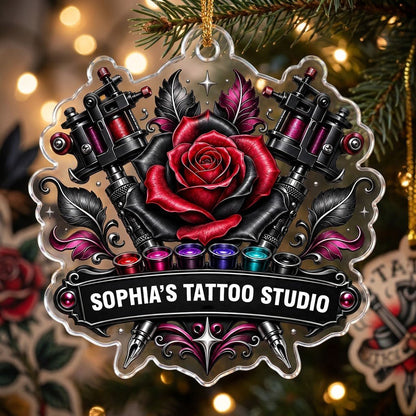 Clear acrylic ornament with red and black rose, crossed tattoo machines, caps, and SOPHIA'S TATTOO STUDIO text.