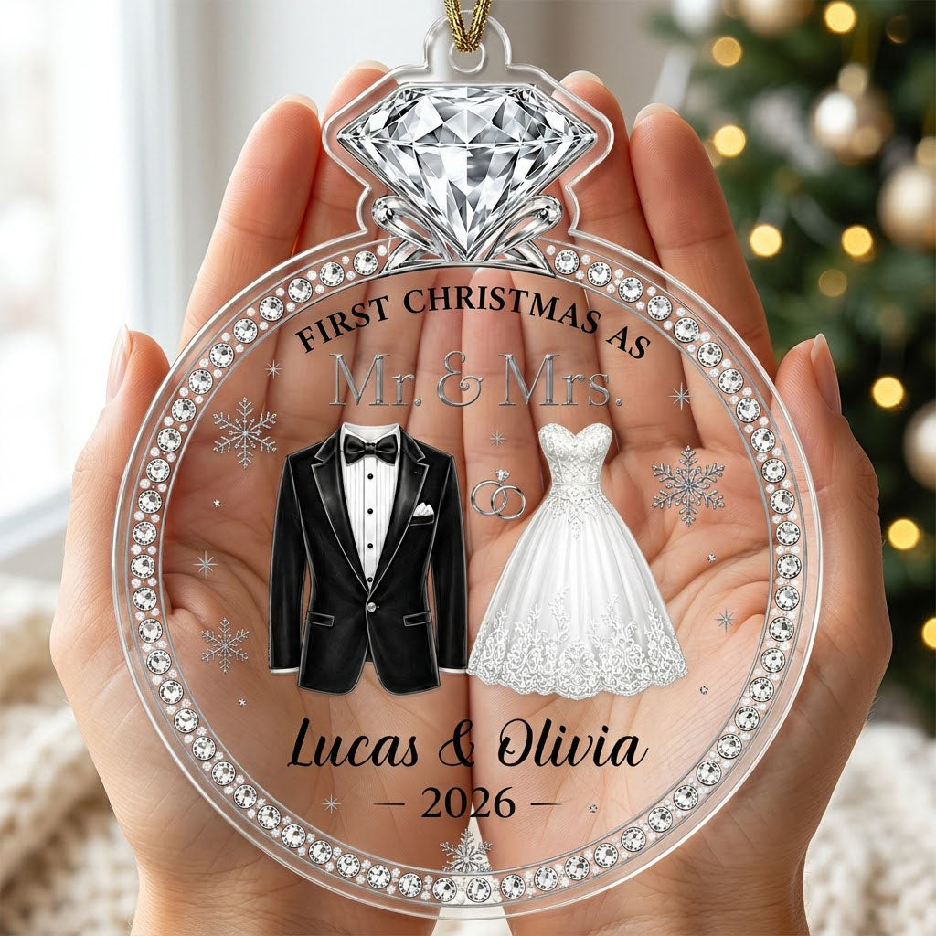 Clear acrylic diamond-ring ornament with tuxedo, lace gown, silver rings and 'First Christmas as Mr. & Mrs.' text.