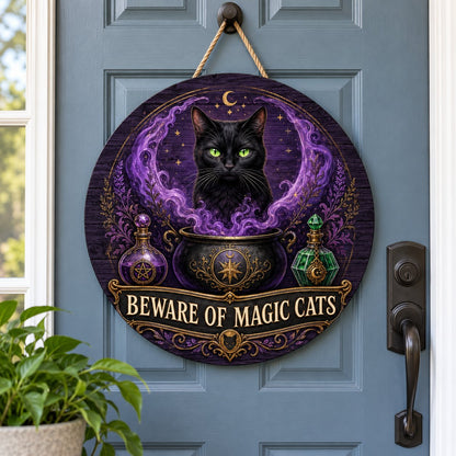 Round wooden sign with a black cat in purple smoke rising from a cauldron and the text BEWARE OF MAGIC CATS.