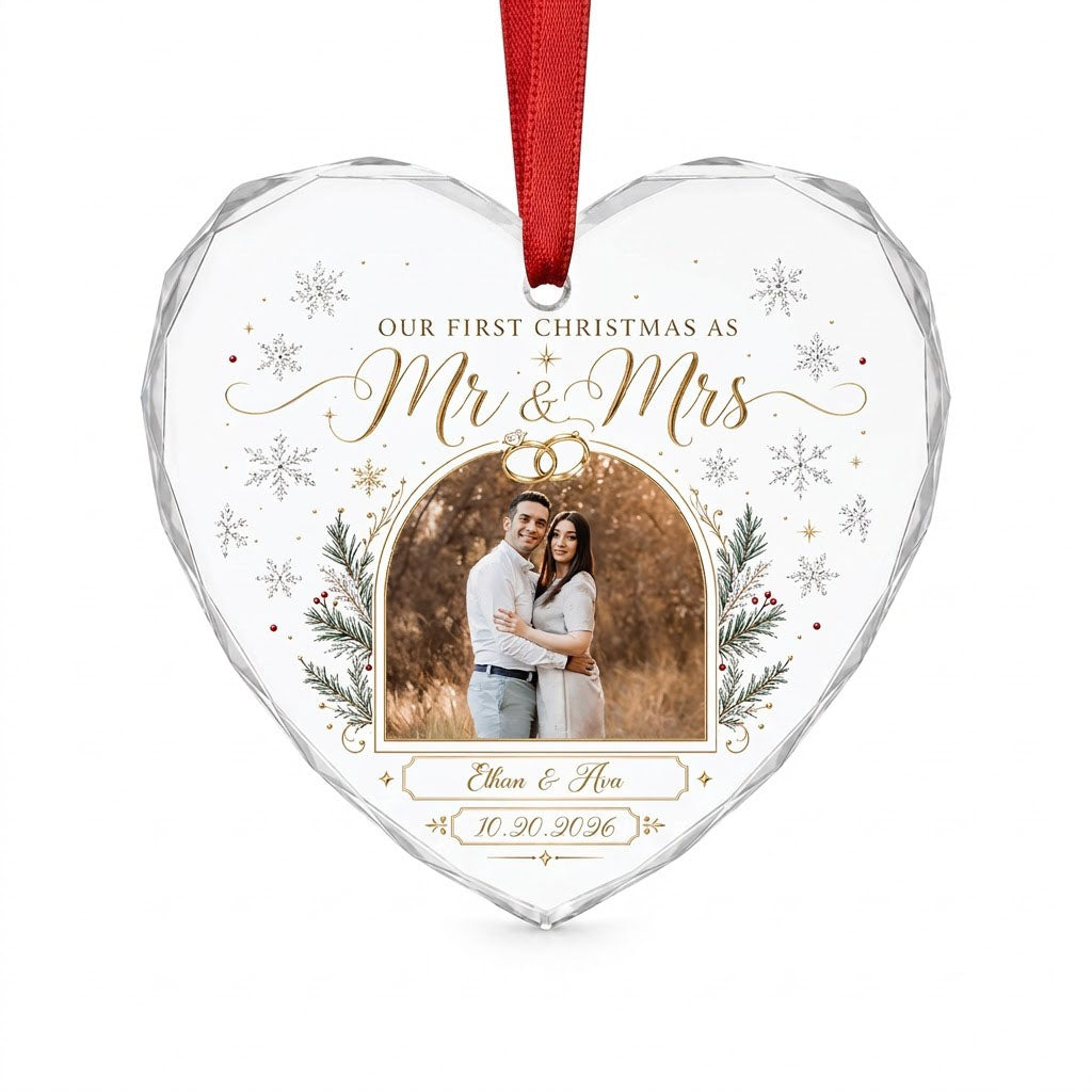Heart-shaped glass ornament with photo, gold wedding rings, pine branches, snowflakes, and Mr & Mrs text.