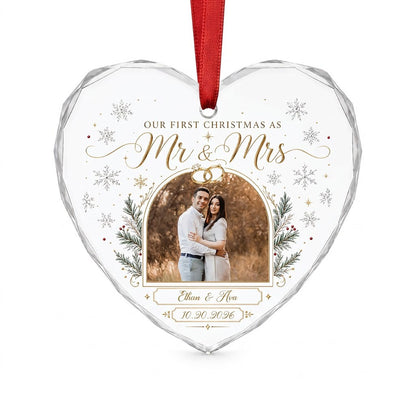 Heart-shaped glass ornament with photo, gold wedding rings, pine branches, snowflakes, and Mr & Mrs text.