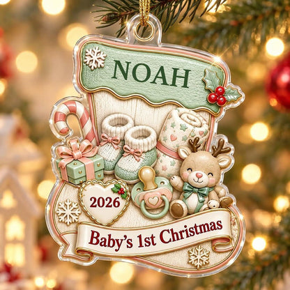 Stocking-shaped acrylic ornament with baby booties, reindeer toy and Baby's 1st Christmas on a cream banner.