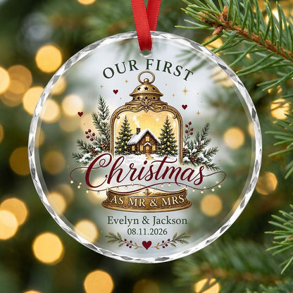 Round glass ornament with gold lantern, cozy cabin, pine branches, holly berries, and Our First Christmas as Mr & Mrs.