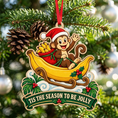 Custom-cut wood ornament with monkey in Santa hat riding a banana sleigh, banner reads TIS THE SEASON TO BE JOLLY.