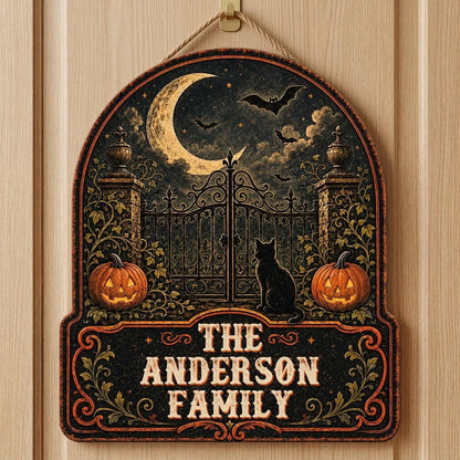 Arched wooden sign with crescent moon, bats, wrought-iron gate, black cat and jack-o'-lanterns with family name.