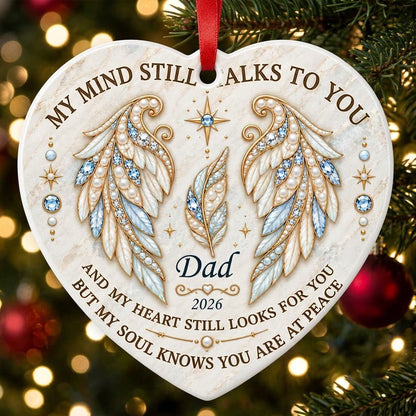 White heart ceramic ornament with jeweled angel wings, blue gems, gold scrollwork, personalized name and year.