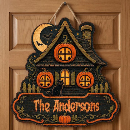 Custom-cut haunted house wooden sign with moon, bats, pumpkin windows, black cat, picket fences, and a family name banne