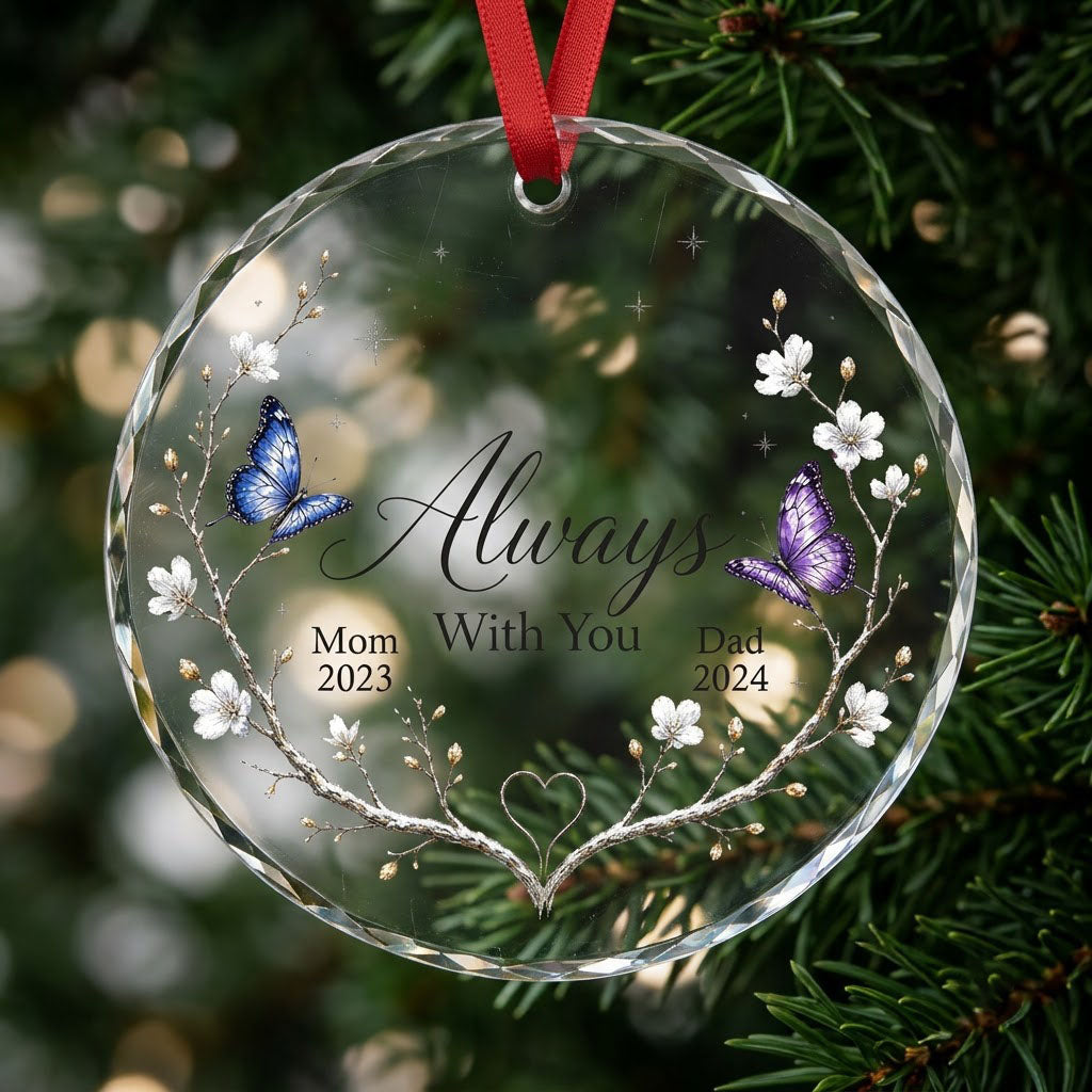 Round glass ornament with branch wreath, white blossoms, blue and purple butterflies, and Always With You text.