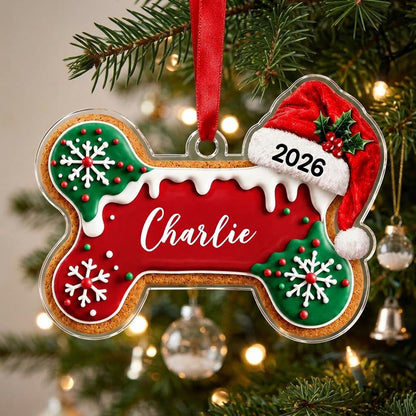 Acrylic ornament shaped like a gingerbread dog bone with Santa hat, white icing, snowflakes, and red-green sprinkles.