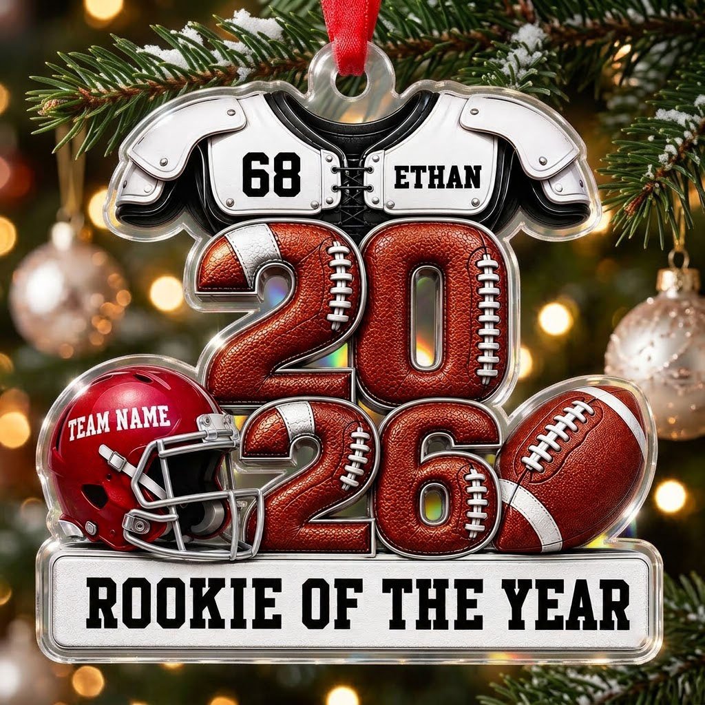Acrylic ornament shaped like football gear with 2026 numbers, red helmet, ball and 'Rookie of the Year' nameplate.