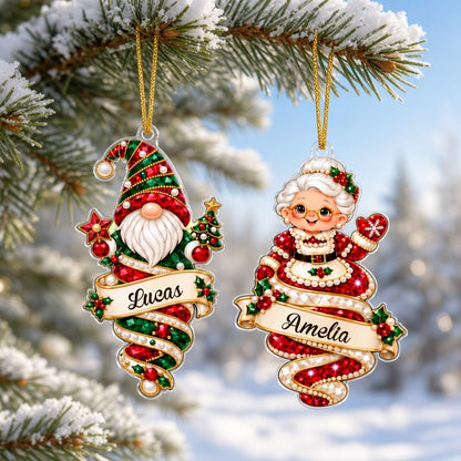 A custom-cut clear acrylic ornament shows a polar bear and Mrs. Claus in a jeweled spiral with a name banner and red rib