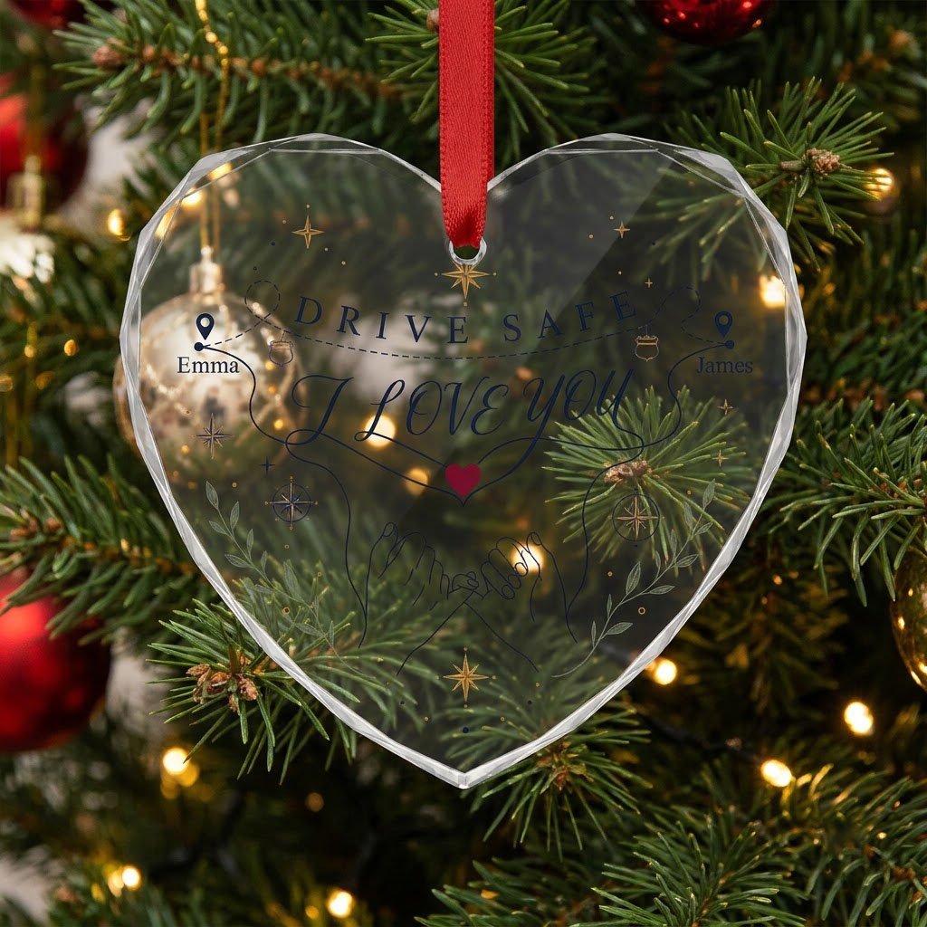 Heart glass ornament showing pinky promise hands, map pins, compass roses, green sprigs, and DRIVE SAFE and I LOVE YOU.