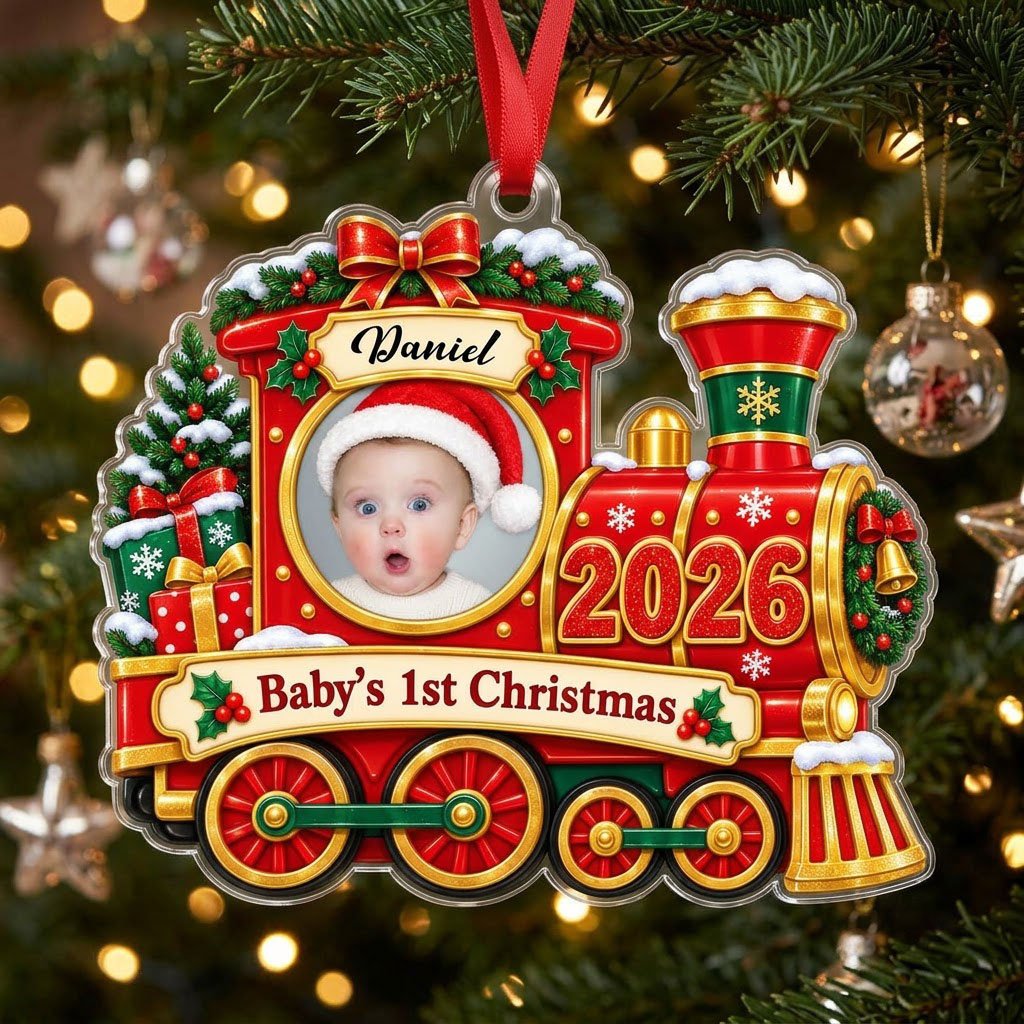 Red and gold train ornament with circular baby photo, bow, holly, wreath and 'Baby's 1st Christmas' on a scroll banner.
