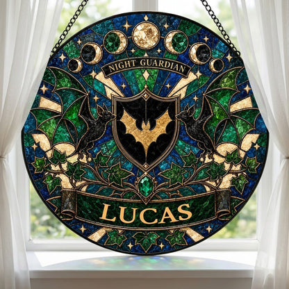 Round stained-glass suncatcher with gold bat shield, two black bats, moon phases, emerald gem, ivy and starbursts.