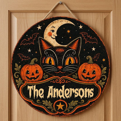 Round wooden sign with vintage black cat face, crescent moon, pumpkins, bats, stars and custom family name.