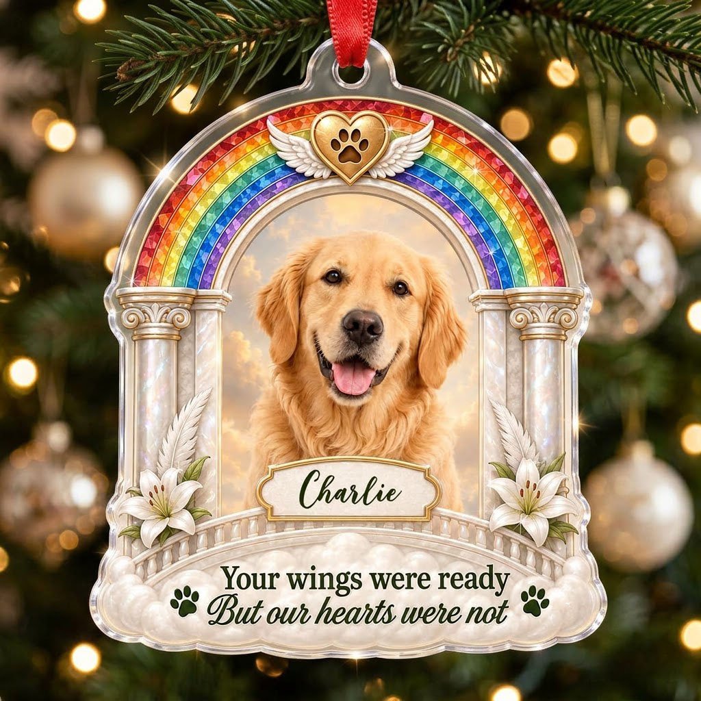 A rainbow arch pet memorial acrylic ornament with a winged golden heart, paw print, lilies, pillars, clouds and a photo 