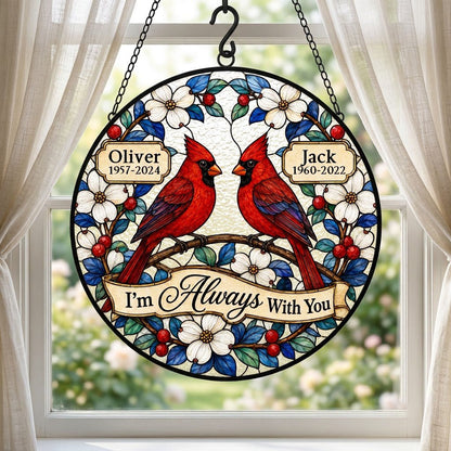 Round suncatcher with two red cardinals on a branch, dogwood flowers, a scroll banner and two name plaques.