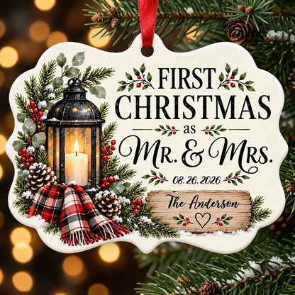 Medallion ceramic ornament with black lantern, pine, red berries, plaid scarf, and 'FIRST CHRISTMAS as MR. & MRS.' text.