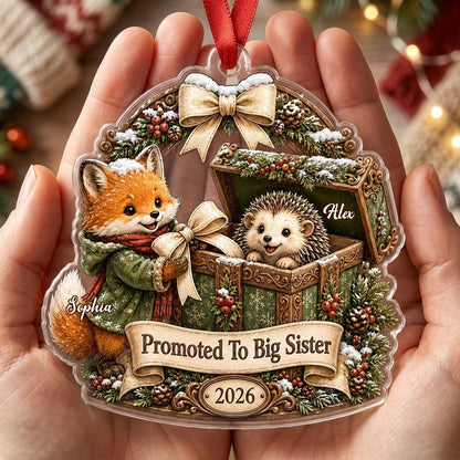 Custom-cut acrylic ornament: fox in jacket, hedgehog in box, pine arch and Promoted To Big Sister banner.
