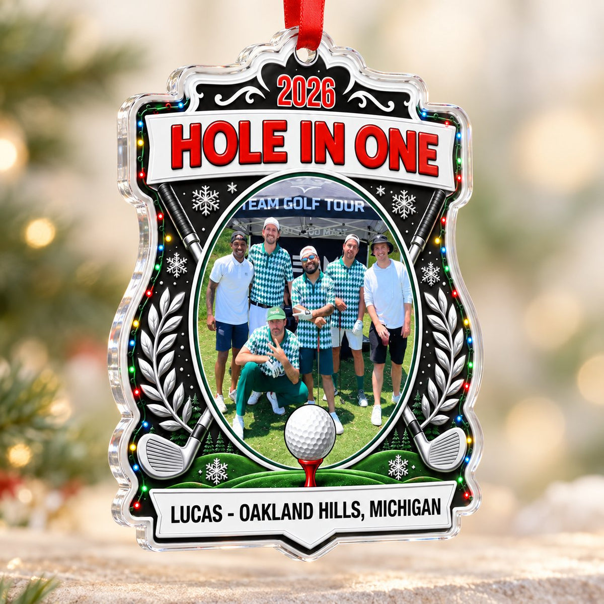 Acrylic crest ornament with golf photo, crossed clubs, Christmas lights, snowflakes, and HOLE IN ONE 2026 text.