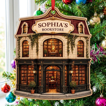 Custom-cut ornament shaped like a vintage bookstore with green and gold storefront and 'BOOKSTORE' text personalized abo