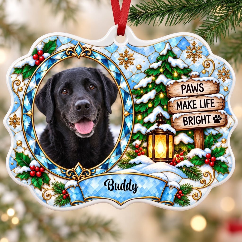 Scalloped ceramic medallion ornament with dog photo, blue stained glass frame, lantern, and Christmas tree in snow.