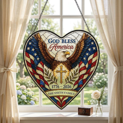 Heart-shaped stained glass suncatcher with a bald eagle over a golden cross and American flag border.