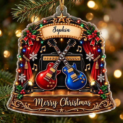 Custom-cut acrylic ornament with crossed red and blue guitars, Merry Christmas marquee, curtains and holly.
