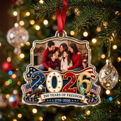 Custom-cut acrylic ornament with '2026', eagle, Statue of Liberty, flags and a gold photo frame.
