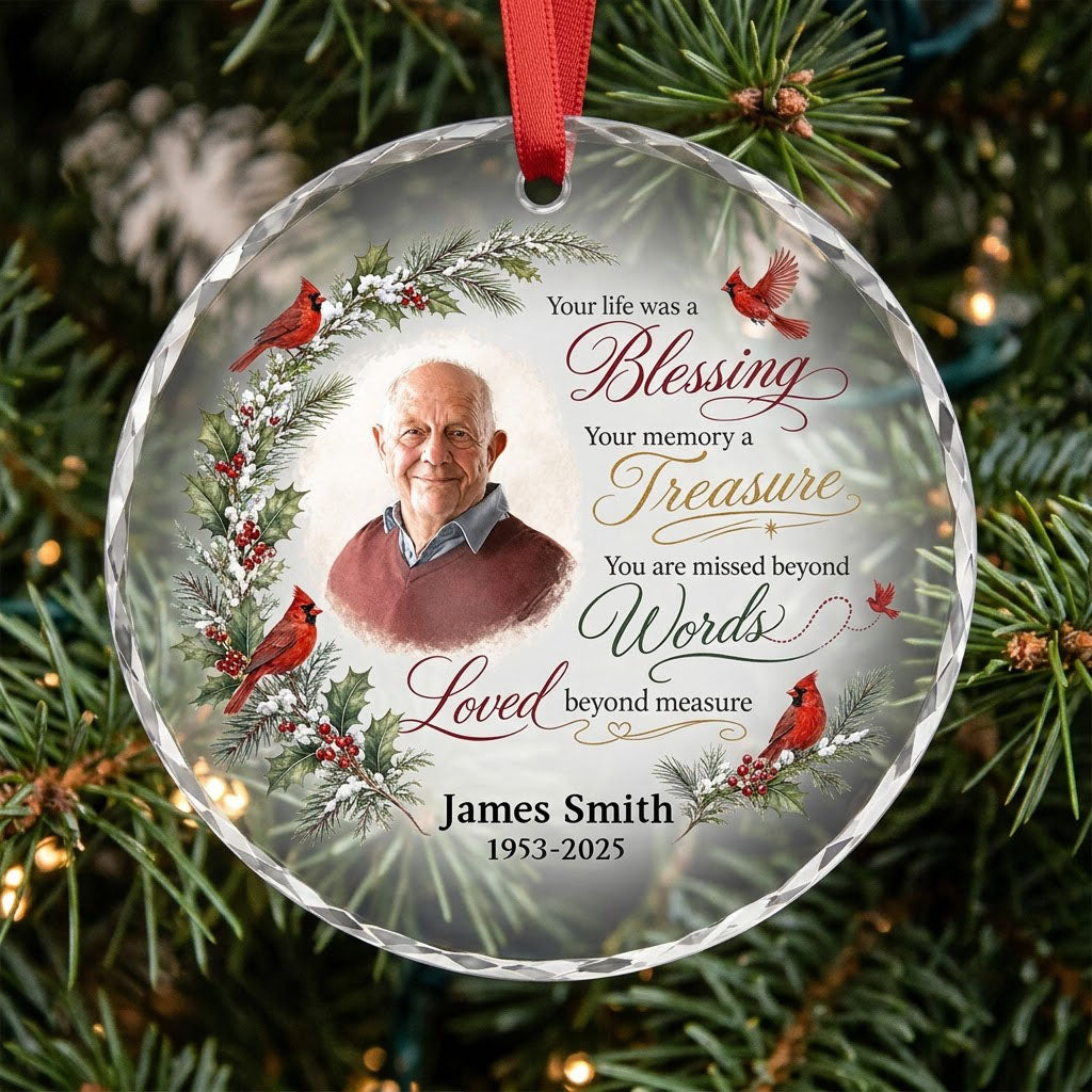 Round glass ornament with memorial quote, four red cardinals, pine and holly greenery, and a center photo portrait.