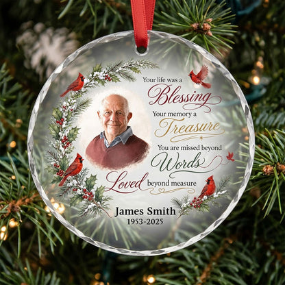 Round glass ornament with memorial quote, four red cardinals, pine and holly greenery, and a center photo portrait.