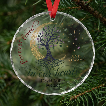 Round glass ornament with Celtic tree of life, gold crescent moon, stars, and phrase Forever loved in our hearts.