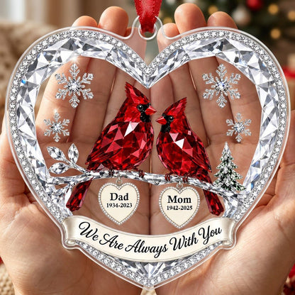 Heart ornament with two red crystal-style cardinals, snowflakes, a ribbon banner, and two dangling name-date heart charm