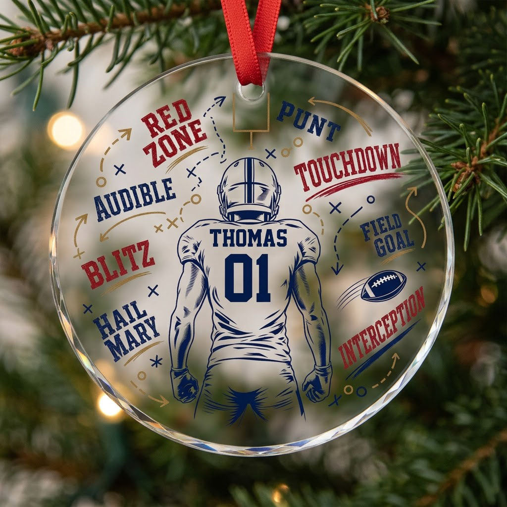 Round faceted glass ornament with football player back view, goalpost, football, and play diagrams in navy, dark red, an