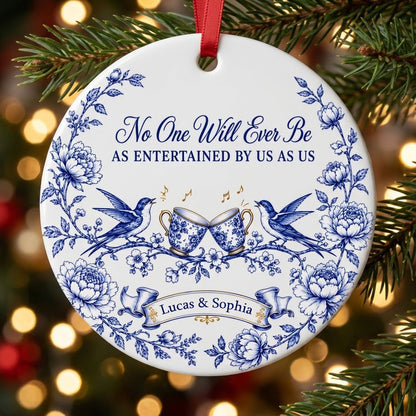 Round ceramic ornament with blue toile border, two birds, clinking floral teacups and gold music notes with two names.