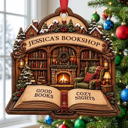 Custom-cut wood ornament with arched loop and open book base, cozy bookshop scene with tree, fireplace, armchair.