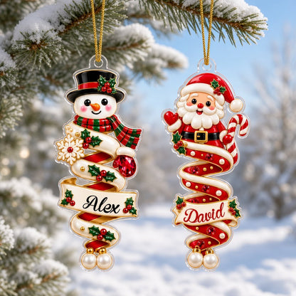 Custom-cut acrylic ornaments with gingerbread and Santa, spiral ribbons, and a holly-framed name banner.